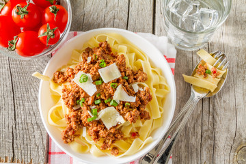 Spaghetti bolognese with salad and tomatoes