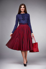 Fototapeta premium Beautiful young sexy woman with long hair brunette perfect sport thin figure tanned body make-up wearing a dress suit skirt collection catalog shirt style fashion accessories store sale businesswoman