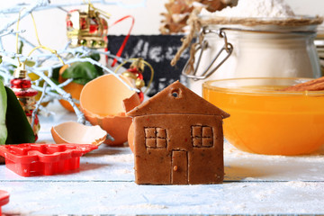 ginger cookies small house  Christmas homemade cakes on a light wooden background selective soft focus rustic style
