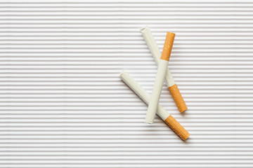 Cigarette on white paperboard background, Overhead view of cigar