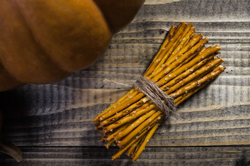 Straws tied together and pumpkin