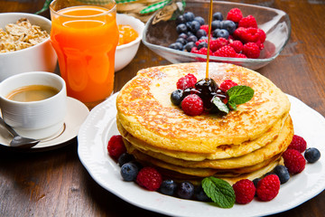 Pancakes with berries and maple syrup