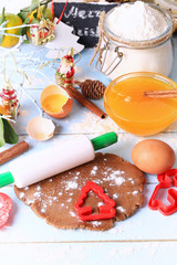 rolled out dough for gingerbread Christmas homemade cakes on a light wooden background selective soft focus rustic style