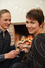 Man and woman holding glasses of sparkling wine.