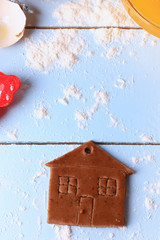 ginger cookies small house  Christmas homemade cakes on a light wooden background selective soft focus rustic style