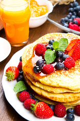 Pancakes with berries and maple syrup
