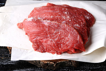 raw beef coarse salt farm organic product on the old wooden background vintage retro