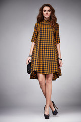 Beautiful young sexy woman with long hair brunette perfect sport thin figure tanned body make-up wearing a dress suit skirt collection catalog shirt style fashion accessories store sale businesswoman