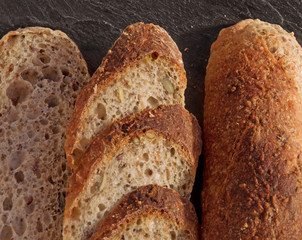 Fresh homemade Alpine Baguette served on black.