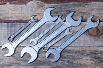 spanners lie on a wooden surface.top view