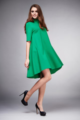 Beautiful young sexy woman with long hair brunette perfect sport thin figure tanned body make-up wearing a dress suit skirt collection catalog shirt style fashion accessories store sale businesswoman