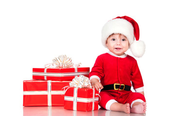 Cheerful little Santa Claus with presents. Isolated on white bac