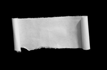 Piece of torn paper on black. Copy space