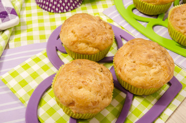 Close up on delicious muffins on colorful napkin. Muffins on heart shape holder.