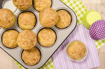 Muffins in a tray on colorful napkins. Twelve muffins in a tin tray.