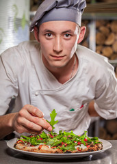 male cook preparing delicious appetizer