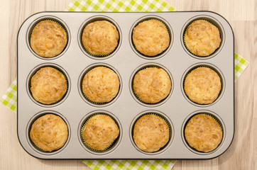 Muffins in a tray. Twelve muffins in a tin tray.