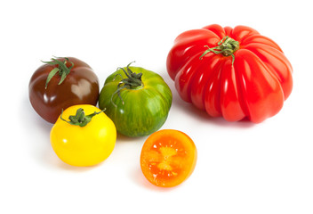 Different colors tomatos, Solanum lycopersicum, on white backgroung