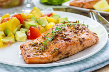 Spice grilled salmon with mango-avocado salsa on a white plate