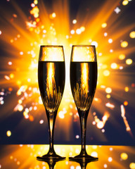 champagne glass silhouette against sparkler background