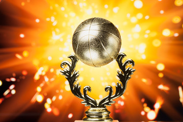 basketball trophy against shiny sparks background