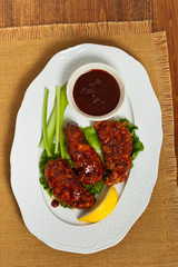 Breaded chicken with barbecue sauce. Selective focus.