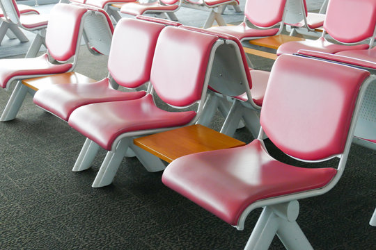 row of pink leather chair at the airport