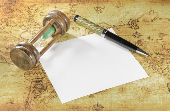 Paper and pen on a old world map