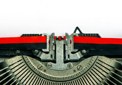 Old typewriter with white paper. Vintage background