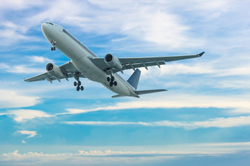 Fototapeta na wymiar Commercial airplane flying with blue sky background