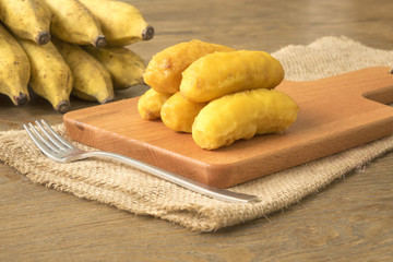 Banana fritters on wooden chopping board