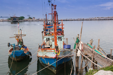 Fototapeta na wymiar fishing boats under sky in harbor 