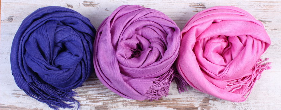 Colorful scarves on old rustic wooden background
