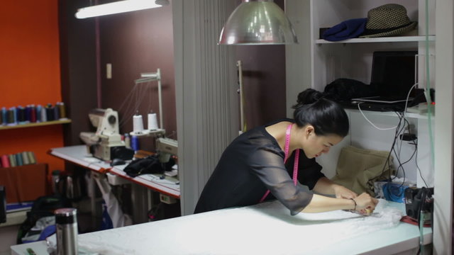 Asian woman tailor fashion clothes dress designer working with fabric