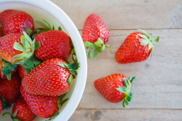 Ripe red strawberries on wooden table