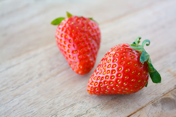 Ripe red strawberries on wooden table