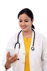 Female doctor looking text message on cellphone - 95683566