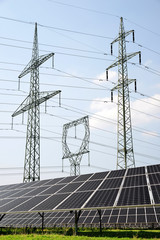 Solar panels with electricity pylons. Green energy concept.