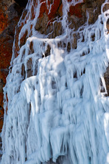 Fototapeta na wymiar Ice over rocks wall on Baikal lake at winter