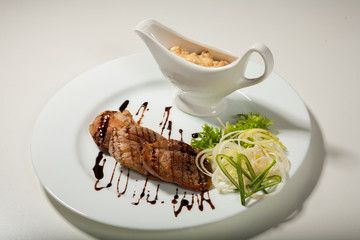 Beautifully decorated meal on a plate on a white background in studio