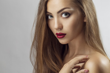 Sexy Beauty Girl with purple-red Lips. Provocative Make up. Luxury Woman with Green Eyes. Fashion Brunette Portrait  on a silver background. Gorgeous Woman Face. Long Hair