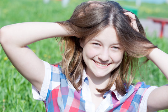 Summer portrait of happy smiling teen girl outdoors