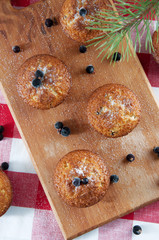 Freshly baked muffins sprinkles with sugar and black currant ber