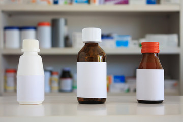 Blank white label of medicine bottle with blur shelves of drug i
