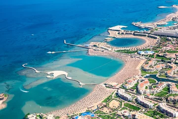 Zelfklevend Fotobehang Sea bays with piers and locations enclosures for swimming and tanning, Egyptian resorts, aerial view, the Red Sea, Egypt © Kekyalyaynen