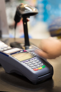Hand Swiping Credit Card In Store