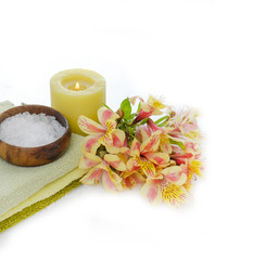 Branch orchid and salt in bowl ,towel ,candle on white