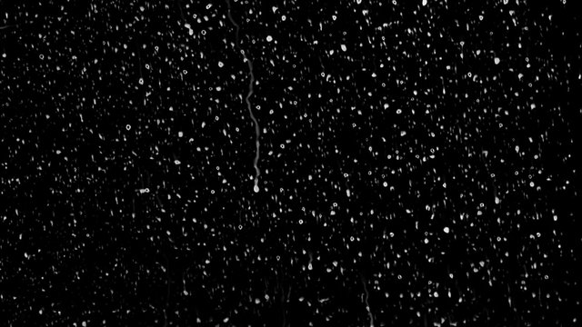 Raindrops of white water falling down on glass. Perfect for digital composing. Pure black background.