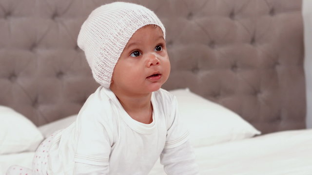  Baby in white clothes crawling 