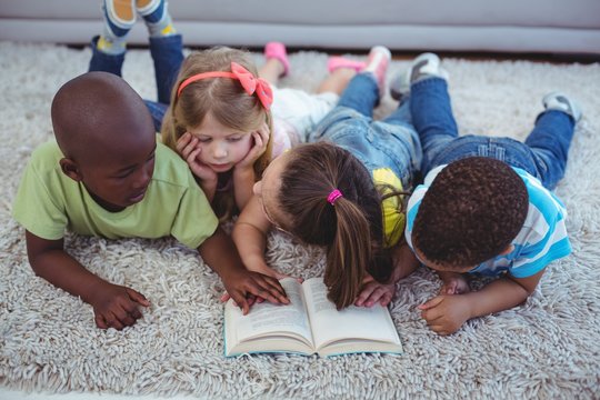 Happy Kids Reading A Book Together